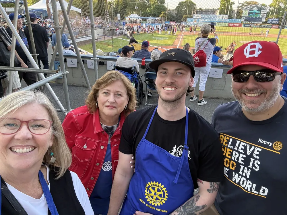 Smiling members volunteering at a baseball game