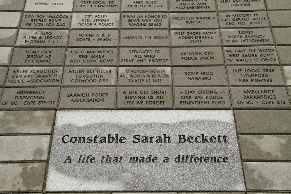 Engraved bricks around a stone reading Constable Sarah Beckett, a life that made a difference